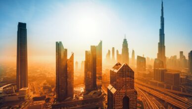 Burj Khalifa at sunset, glowing against the Dubai skyline with vibrant hues of orange and pink