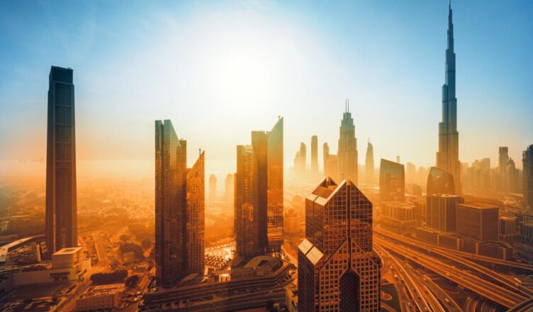 Burj Khalifa at sunset, glowing against the Dubai skyline with vibrant hues of orange and pink